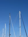 Sailboat masts in the marina against a blue summer sky Royalty Free Stock Photo