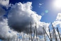 Sailboat masts under clouds - sunny day Royalty Free Stock Photo