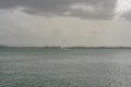 Sailboat in the middle of the ocean on a stormy rainy day Royalty Free Stock Photo