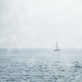 Sailboat on Misty Blue Seas