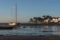 a sailboat moored on the Arcachon Basin and coastal houses in the beautiful lights of the sunrise and the morning mist