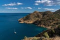 sailboat moored in a bay of the Serra Gelada Natural Park with the Albir Lighthouse in the background Royalty Free Stock Photo