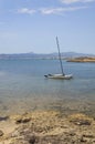 Sailboat moored in shallow water Cala Estancia Royalty Free Stock Photo