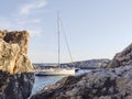 Sailboat mooring in a small cove of beach Velo Zarace on Hvar island, Croatia in sunset Royalty Free Stock Photo