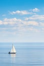 Sailboat navigating open waters under blue sky