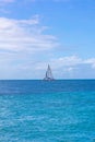 Sailboat navigating a tranquil blue ocean