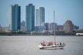 A sailboat in New York harbor Hudson river Jersey City background