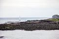 Sailboat in Oarweed Cove on Marginal way path along the rocky coast of Maine in Ogunquit Royalty Free Stock Photo