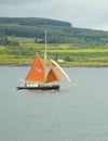 Sailboat with Orange Sails on the Sound of Mull, Scotland, UK. Royalty Free Stock Photo