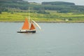 Sailboat with Orange Sails on the Sound of Mull, Scotland, UK. Royalty Free Stock Photo