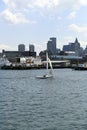 Sailboat passes Coast Guard in Boston Harbor