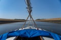 Sailboat passing by channel waterway or river. Concept of travel, adventure and vacation. Royalty Free Stock Photo