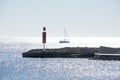 Sailboat and pier with inlet on a bright sunny day Royalty Free Stock Photo