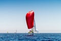 Sailboat with red gennaker competing during regatta Royalty Free Stock Photo