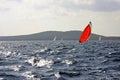 Sailboat with red Kodak spinnaker during the regatta Split - Vis