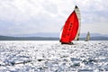 Sailboat with red Kodak spinnaker during the regatta Split - Vis