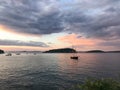 A sailboat rests in the harbor of Frenchman Bay in Bar Harbor, Maine at sunset with clouds rolling in Royalty Free Stock Photo