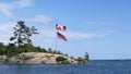 Canadian and American flags greet boaters as they enter Killarney Channel on Georgian Bay, Ontario Royalty Free Stock Photo