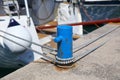 Sailboat ropes tied to marina bollard Royalty Free Stock Photo