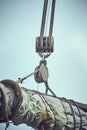 Sailboat ropes wooden pulley rigs. Part of a sail boat. Close-up view of sailboat ropes, pulleys and ropes on the mast, Yachting s Royalty Free Stock Photo