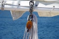 Sailboat sail and wooden rigging ropes against water background Royalty Free Stock Photo