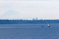 Sailboat Sailing Against the Horizon with Mount Rainier Royalty Free Stock Photo