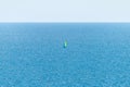 Sailboat sailing alone in vast blue Gulf of Mexico off the coast of Panama City Beach Florida