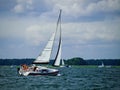 Sailboat sailing on a lake in a windy sunny summer day Royalty Free Stock Photo
