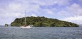 Sailboat sailing past Stewart Island, New Zealand