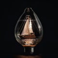 A sailboat sailing on the sea inside a large glass bulb, on a black background, close-up, unusual background,