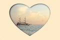 Sailboat sailing on the sea at sunset in the shape of a heart, collage