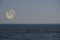 Sailboat sailing under a full moon Royalty Free Stock Photo