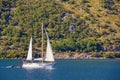 Sailboat sails near shore of Bay of Kotor . Montenegro. Travel concept Royalty Free Stock Photo