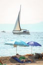 Sailboat sails next to the beach