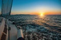 Sailboat with sails set to Sea at full speed at amazing sunset. Royalty Free Stock Photo