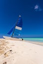 Sailboat on the sandy beach of the Playa Paradise of the island of Cayo Largo, Cuba. Copy space for text. Vertical. Royalty Free Stock Photo
