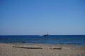 Sailboat on the sea horizon on a sunny September day. Kolimpia, Rhodes, Greece