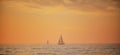 Sailboat in the sea. Sunrise over the sea and beautiful cloudscape. Colorful ocean beach sunset. Royalty Free Stock Photo