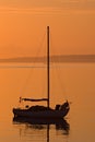 Sailboat silhouette during orange sunrise