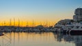 Sailboat silhouettes, magnificent golden warm sunset in Ibiza marina.