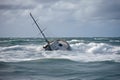 sailboat in stormy waters, capsized and sinking