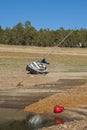 sailboat stranded on land due to drought with blue sky trees in the background vertical Royalty Free Stock Photo