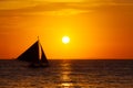 Sailboat at sunset on a tropical sea. Silhouette photo.