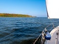 Sailboat on Thisted Bredning along wooded coast of Thisted, Limfjord, Nordjylland, Denmark