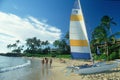 Sailboat and tourist on beach in Hawaii Royalty Free Stock Photo