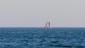 Sailboat with touristen in far away in a mediterranean sea, near town Palamos in Costa Brava
