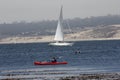 Sailboat Under Mainsail Comming Into Bay With Overcast Sky