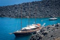 Sailboat by volcano in santorini/firostefani Royalty Free Stock Photo