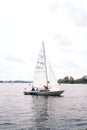 Sailboat with a white sail on the Alster lake in Hamburg Germany