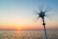 Sailboat with wind turbine sailing on North Sea at sunset, Nethe